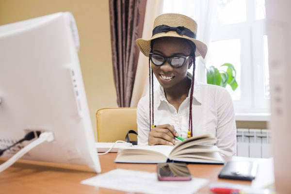 young-black-woman-with-book-table-min